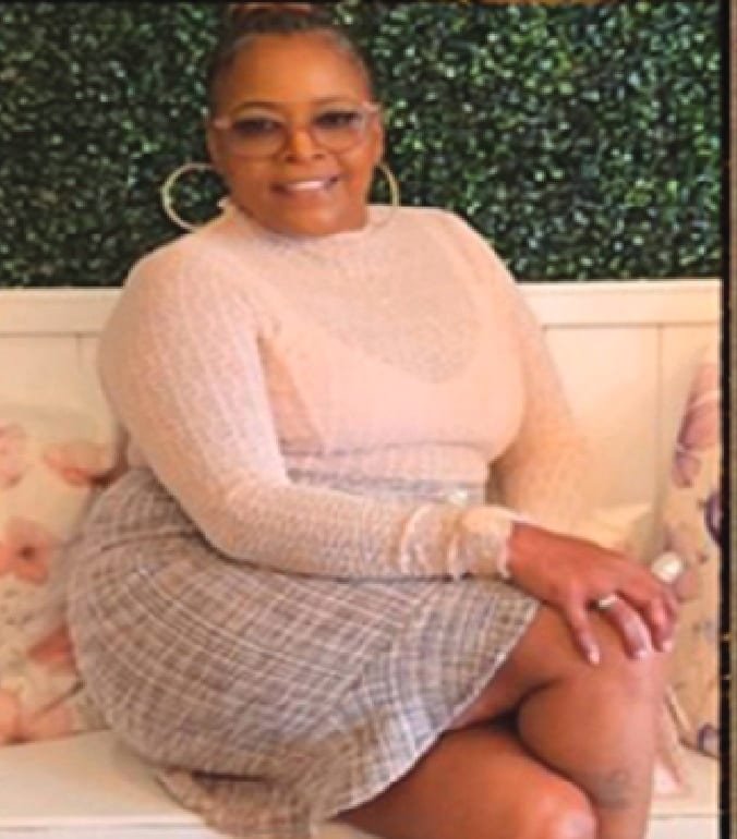Portrait of Elise Serenity, author of The Warrior in the Mirror, seated and smiling